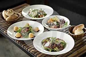 Several different fresh salad dishes on restaurant table
