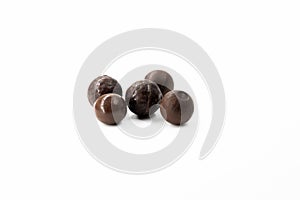 Several different round brown chocolate candies on a white background