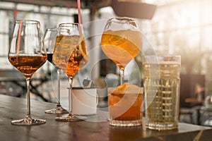 Several different smoothies in glasses of different shapes on the bar