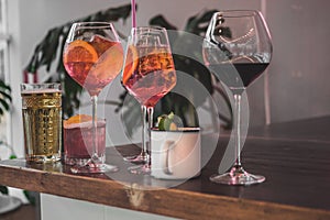 Several different smoothies in glasses of different shapes on the bar