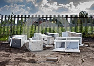 Several discarded fly-tipped fridges and freezers.