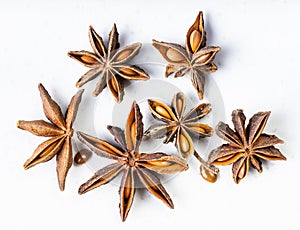 Several dried star anise badian fruits on gray