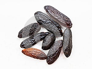 Several dried tonka beans close up on gray