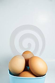 several eggs in a blue container isolated on a white background