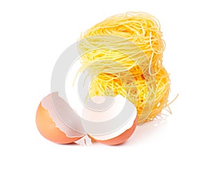 Several eggs and pasta on a white