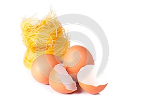 Several eggs and pasta on a white