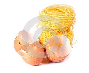 Several eggs and pasta on a white