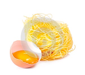 Several eggs and pasta on a white