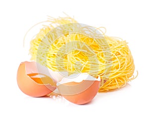 Several eggs and pasta on a white