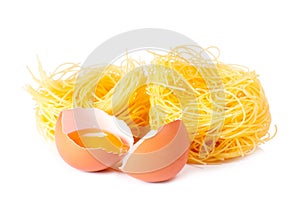 Several eggs and pasta on a white