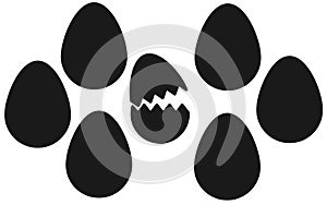 Several eggs silhouette against a white backdrop one shell is cracked open