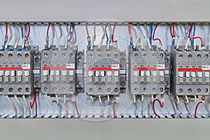 Several electrical contactor on a mounting panel in electrical closet.
