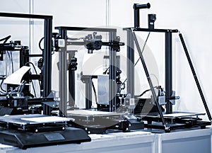 Several empty non-printing 3D printers are on the table.