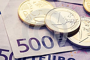 Several 500 euro banknotes and coins are adjacent. Symbolic photo for wealth. photo