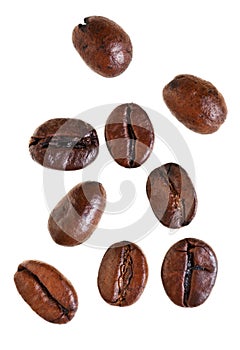 Several falling roasted coffee beans