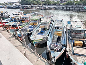 Several fishing boats lean neatly at the pier photo