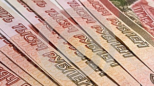 Several five-thousand-dollar bills lie in a fan. Banknotes of 5000 rubles. Cash banknotes. Background of cash ruble notes.