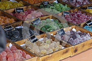 Several flavored candies on wooden boxes photo