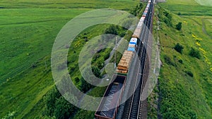 Several freight cars moving above a railway line.