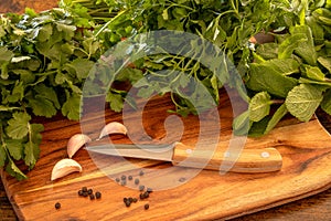 Several fresh herbs on a wooden background