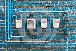 Several gas meters located on the wall of a residential building