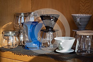 Several glass and ceramic pour over devices closeup in coffee shop