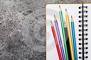 Several graphite pencils on notepad with copy space