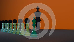 Several green Chess Pawns lined up with the Chess King at the forefront, the concept of leadership in an organization