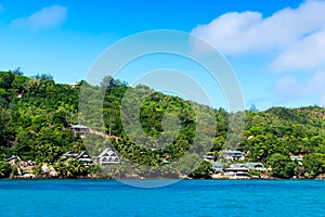 Several hotels on green shore of La Digue island, Seychelles.