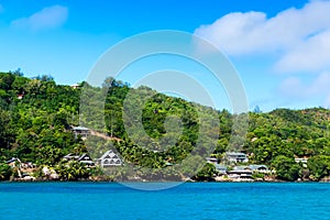 Several hotels on green shore of La Digue island, Seychelles. photo