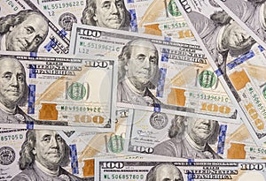 Several hundred dollars bills spread