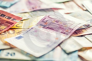 Several hundred euro banknotes stacked by value