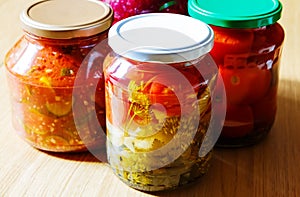 Several jars of tinned vegetables on a wooden table