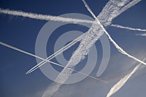 JET AIRCRAFT VAPOUR TRAILS IN CLEAR BLUE SKY photo