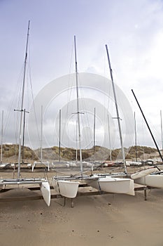 Several katamaran boats on beach