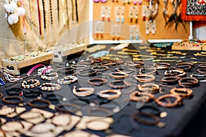 Several leather bracelets are arranged on the display for sales