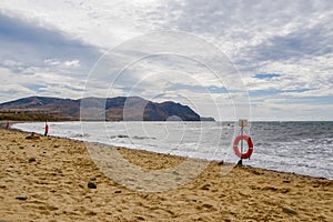 Several lifebuoys on a sandy sea beach