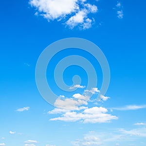 Several light cumuli clouds in blue sky photo
