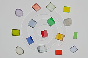 several lonely transparent colored plastic resin granulates for background photo