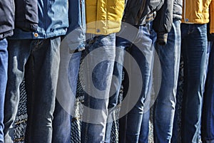 Several mannequins dressed in winter jackets and jeans