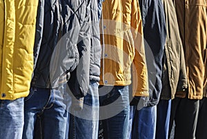 Several mannequins dressed in winter jackets and jeans