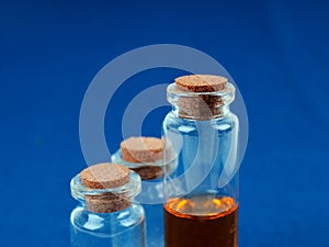 Several medical bottles, test tubes with a cork on a blue background