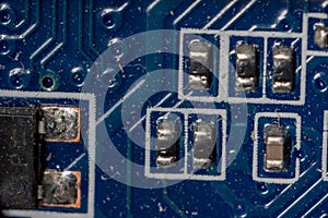 Several microcircuits on a motherboard in a dusty personal computer close-up