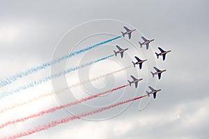 Several military aircraft releasing a multicolored smoke