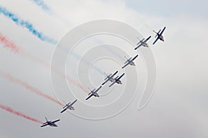 Several military aircraft releasing a multicolored smoke