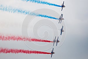 Several military aircraft symmetrically perform aerobatics