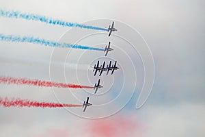 Several military aircraft symmetrically perform aerobatics