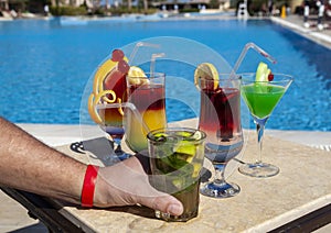 A hand holding a glass with cocktail