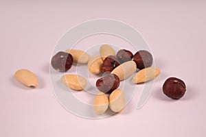 several nuts almonds and hazel on a white background in a chaotic close-up