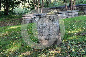 Numerous old weathered headstones and lengths of stonewalls, Walloon Cemetery, historic Huguenot Street, New York, 2018